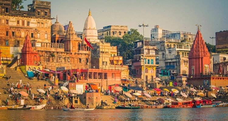Varanasi’s glowing city lights reflecting over the Ganga, showcasing timeless spiritual beauty