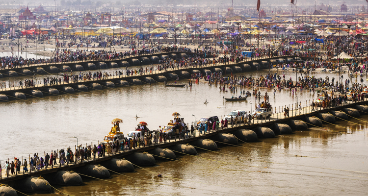Join devotees with families at Triveni Sangam, where three rivers unite, offering peace and salvation
