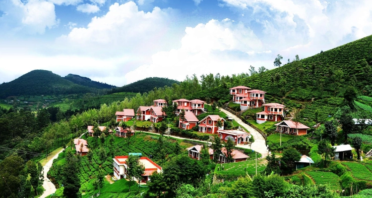 A hilltop village with charming homes nestled in green landscapes and rolling hills under a blue sky.